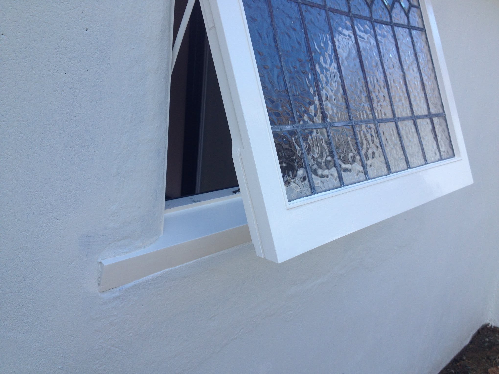 Restored leadlight sash in fresh white, still opening cleanly